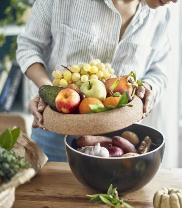 Deep storage bowl with lid holding fresh fruits and vegetables on a kitchen counter